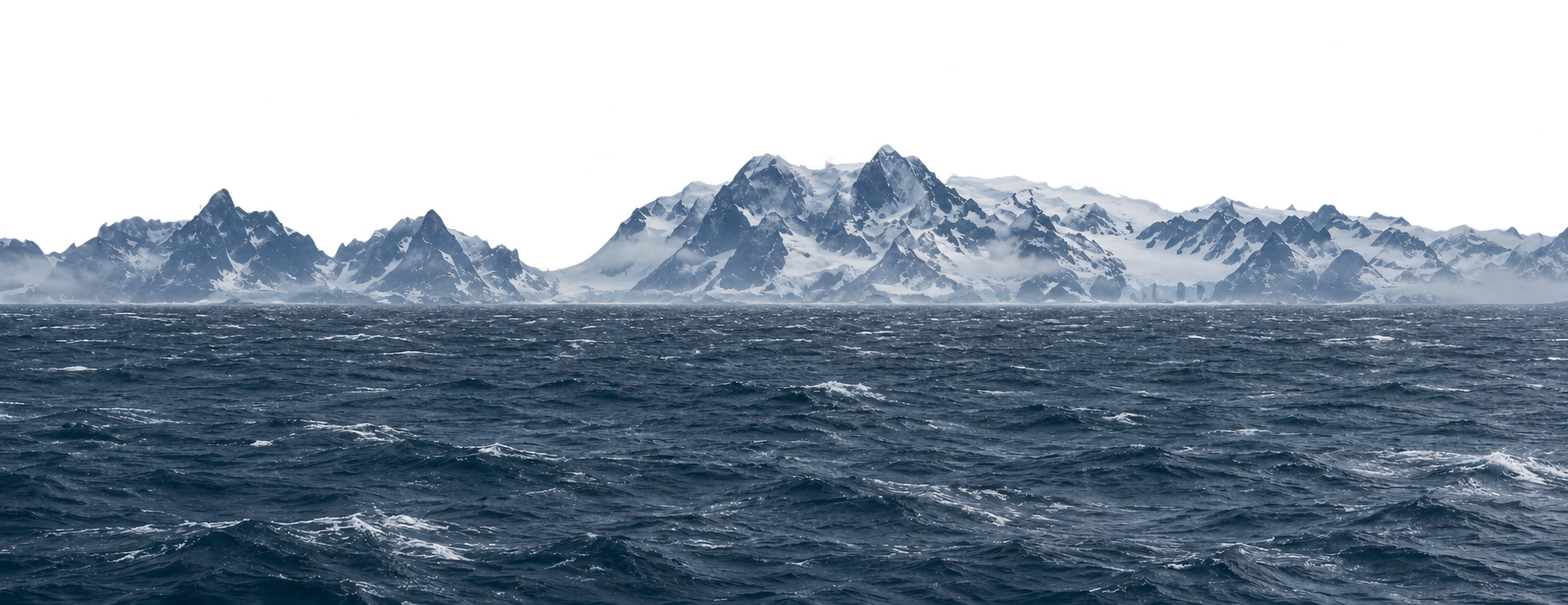 Rough dark ocean and whitecaps beneath a distant snow-covered mountain range.